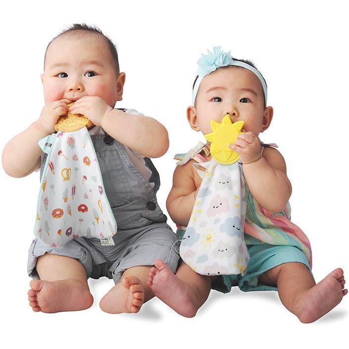 sweet and salty Munch-It Blanket- a convenient teether and cozy blanket for baby. Designed to target baby's emerging front& eye teeth as well as early molars.  The soft blanket is perfect for snuggling and absorbing drool